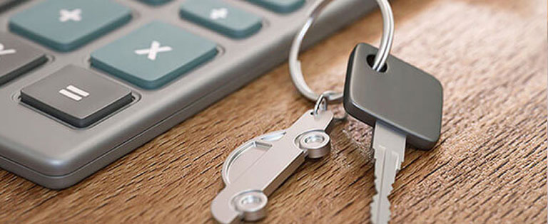 Car key placed next to a calculator